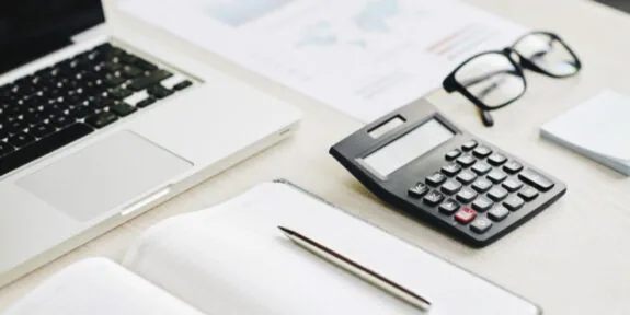 Calculator and documents on a desk